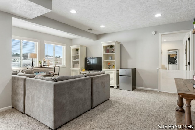 living room with light carpet and a textured ceiling