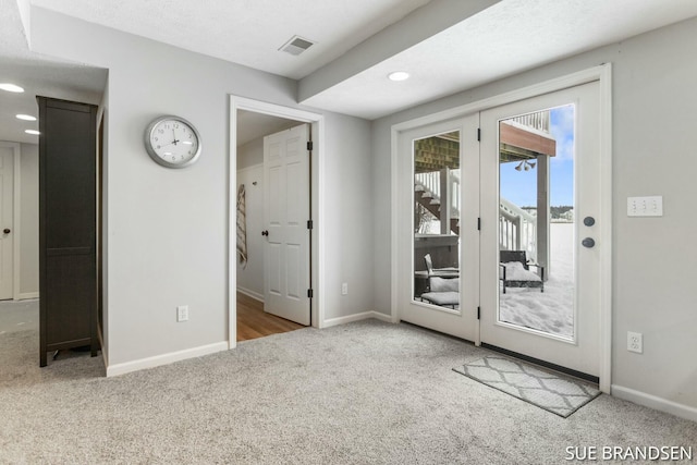 doorway to outside with light colored carpet