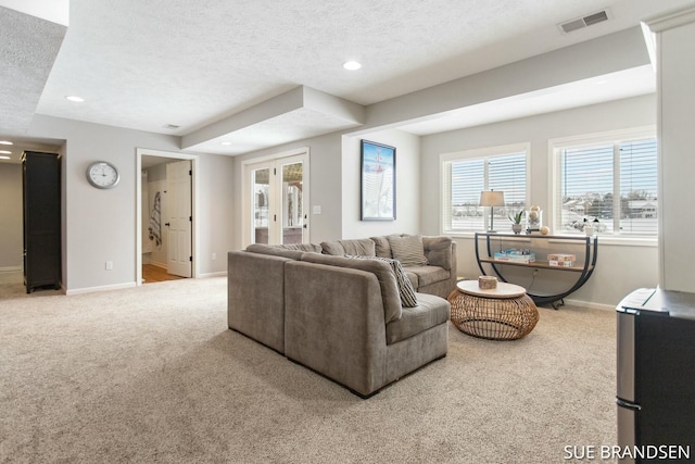 carpeted living room featuring a textured ceiling