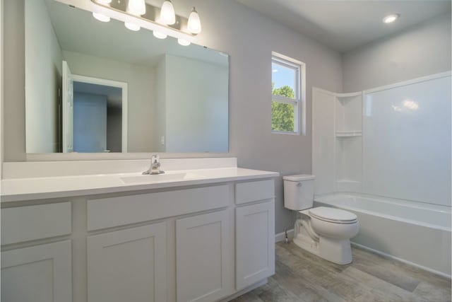 full bathroom with wood-type flooring, toilet, shower / tub combination, and vanity