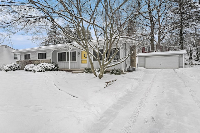 view of front of home featuring a garage and central AC