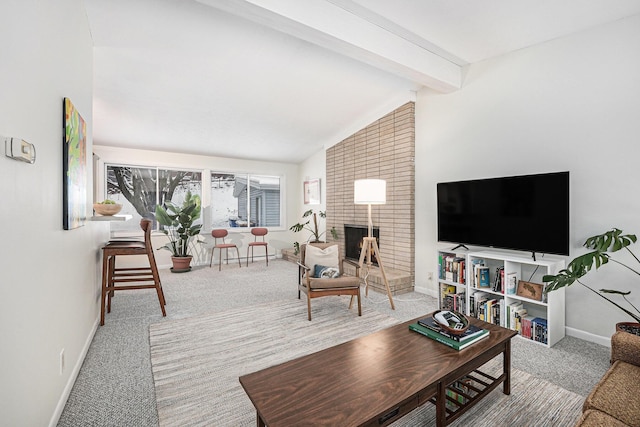 carpeted living room with vaulted ceiling with beams and a fireplace