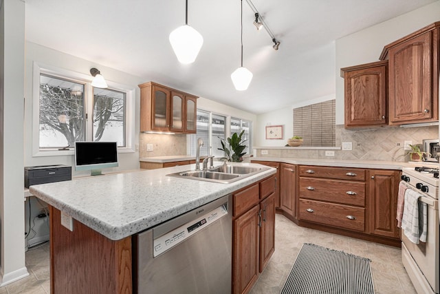 kitchen featuring dishwasher, decorative light fixtures, sink, white range with gas stovetop, and a center island with sink