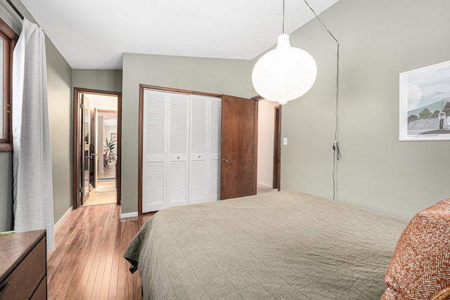 bedroom featuring a closet, lofted ceiling, and wood-type flooring