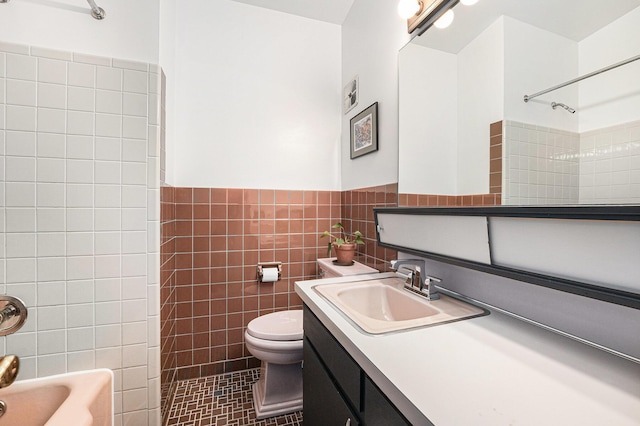 full bathroom featuring toilet, vanity, tile patterned flooring, tile walls, and bathtub / shower combination