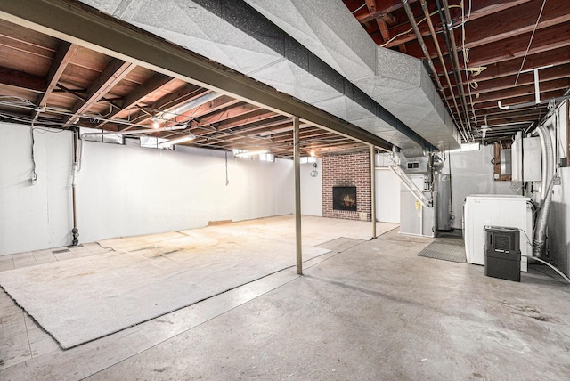 basement with water heater and a brick fireplace