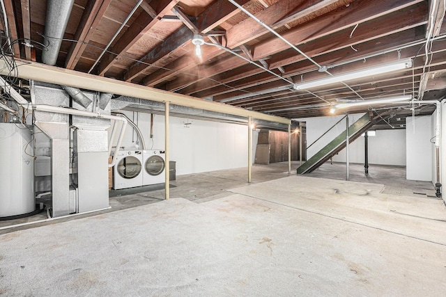 basement featuring water heater and washing machine and clothes dryer