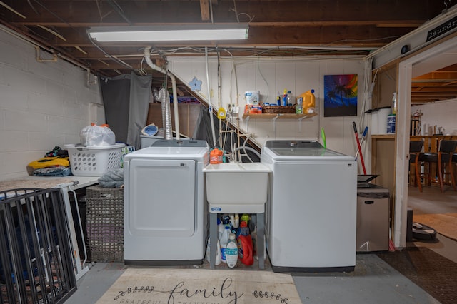 laundry room with washing machine and dryer and sink