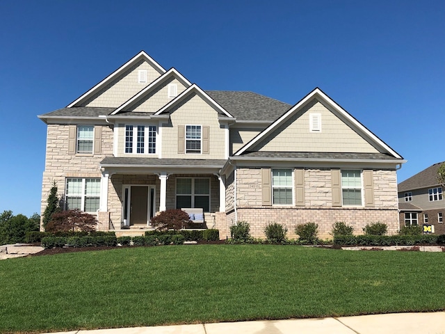 craftsman-style home with a front lawn and a porch