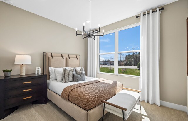 carpeted bedroom featuring an inviting chandelier