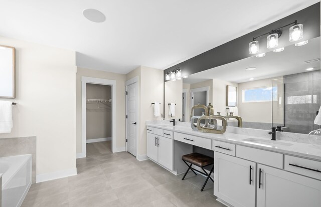 bathroom featuring vanity, independent shower and bath, and tile patterned flooring