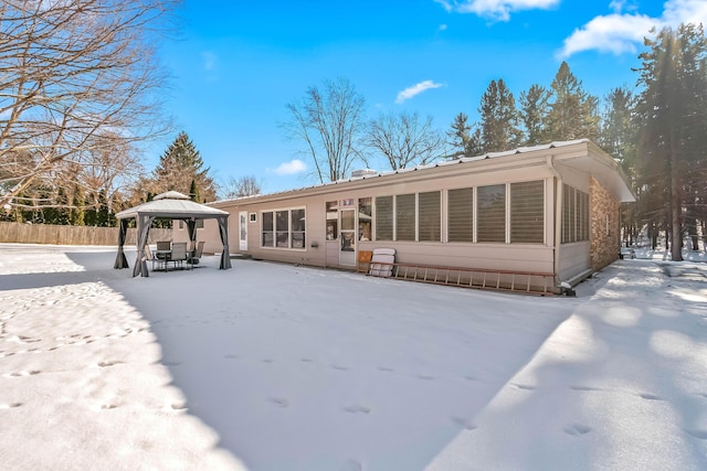 snow covered house featuring a gazebo