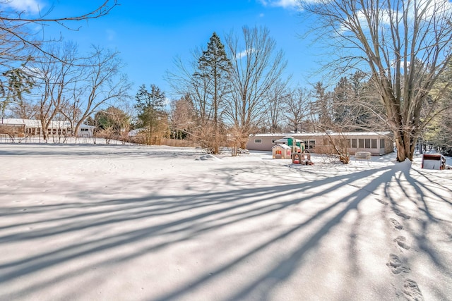 yard layered in snow with a playground