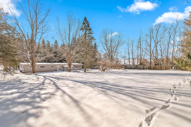 view of yard layered in snow