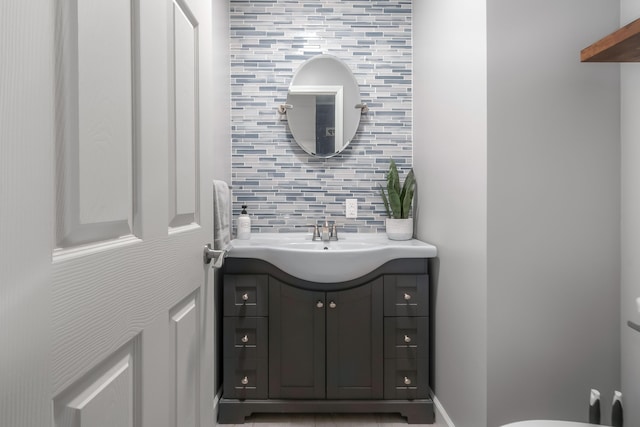 bathroom with decorative backsplash and vanity