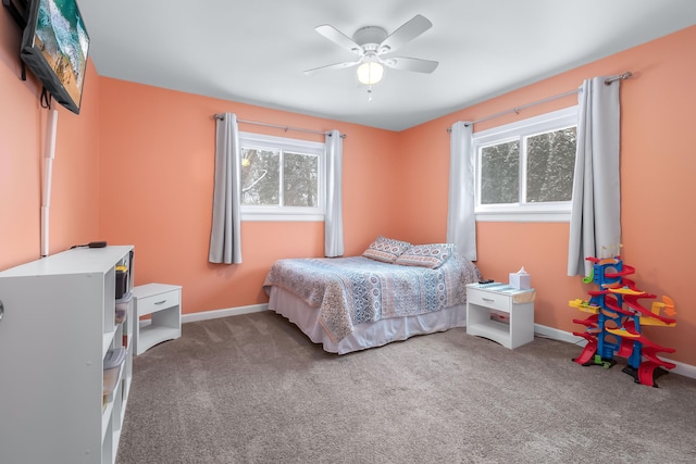 carpeted bedroom featuring ceiling fan and multiple windows