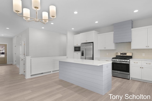 kitchen with light countertops, appliances with stainless steel finishes, light wood-type flooring, and white cabinetry