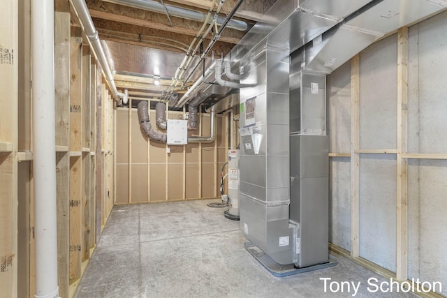 utility room featuring heating unit and gas water heater