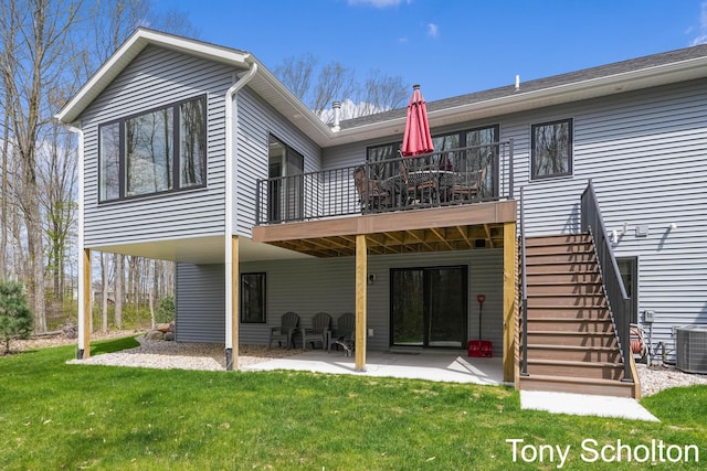 rear view of house with a lawn, central AC unit, stairway, a balcony, and a patio