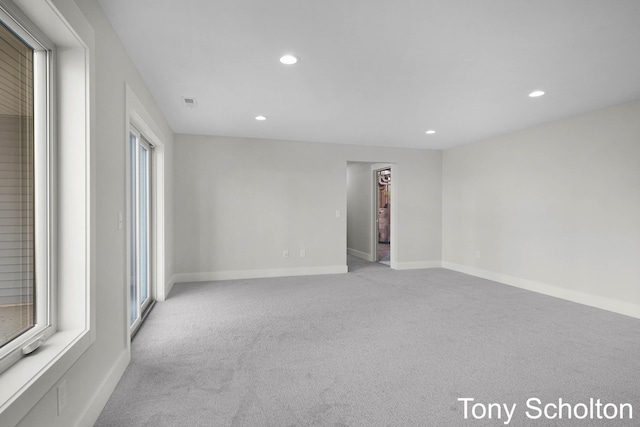 carpeted spare room featuring recessed lighting and baseboards
