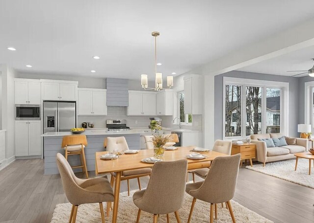 5157 Blendon Wds Ct Unit 15, Hudsonville, MI 49426 - dining room with light wood-style flooring, a chandelier, recessed lighting, and ceiling fan