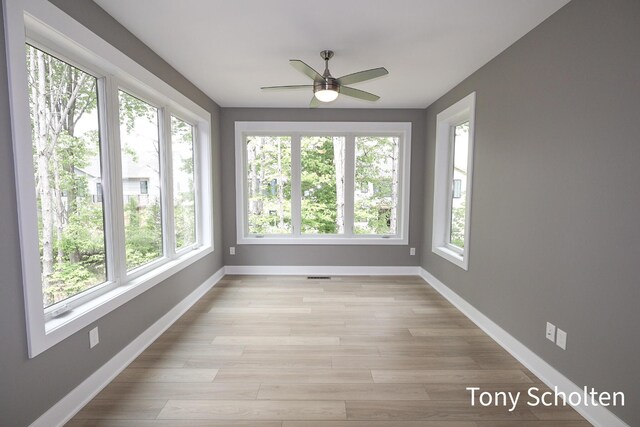5157 Blendon Wds Ct Unit 15, Hudsonville, MI 49426 - unfurnished sunroom with plenty of natural light, baseboards, and wood finished floors