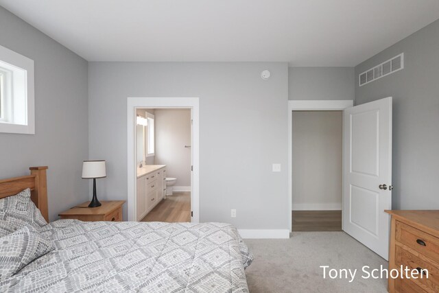 5157 Blendon Wds Ct Unit 15, Hudsonville, MI 49426 - bedroom featuring baseboards, light colored carpet, and ensuite bath