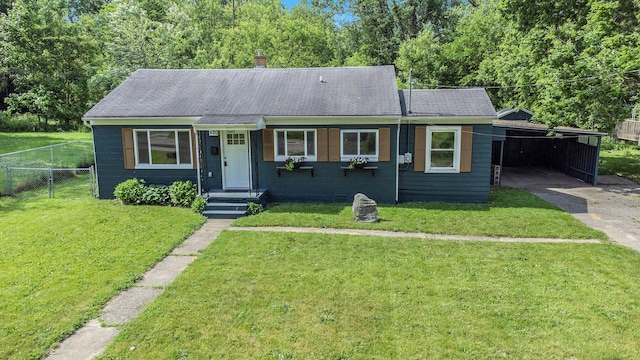 view of front of property with a front yard and a carport