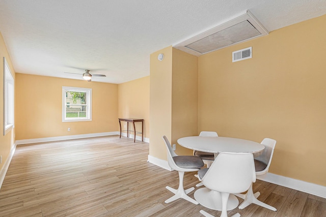 dining space featuring ceiling fan and light hardwood / wood-style floors