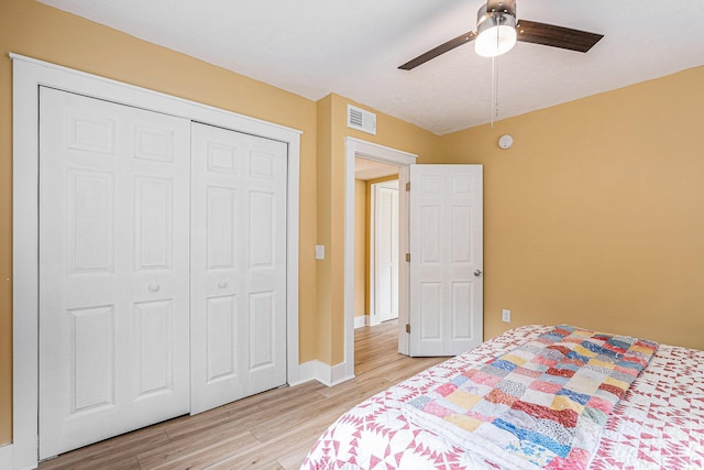 bedroom featuring ceiling fan, a closet, and light hardwood / wood-style flooring