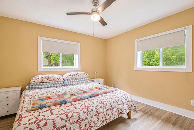 bedroom with ceiling fan and hardwood / wood-style flooring