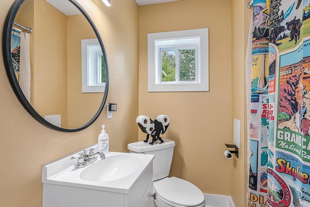 bathroom featuring toilet and vanity