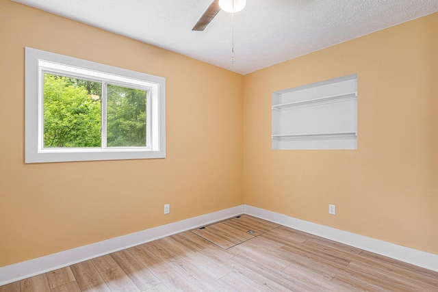 spare room featuring light hardwood / wood-style floors, a textured ceiling, and ceiling fan