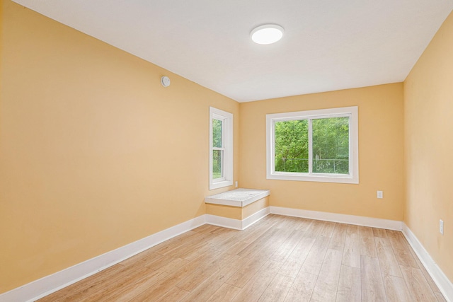 unfurnished room with light hardwood / wood-style flooring