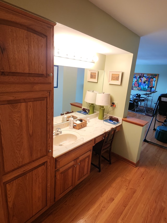 bathroom with hardwood / wood-style flooring and vanity