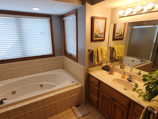 bathroom with plus walk in shower, vanity, and tile patterned flooring