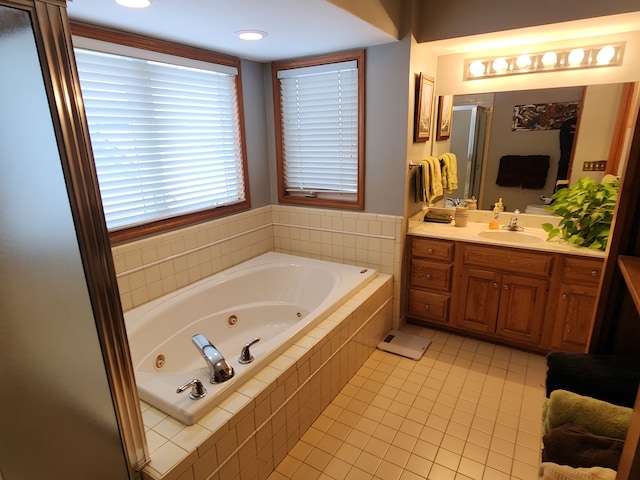 bathroom featuring vanity, independent shower and bath, and tile patterned flooring