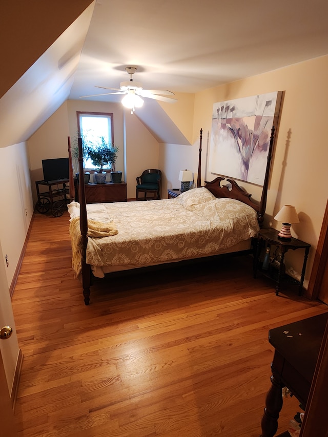 bedroom featuring ceiling fan, lofted ceiling, and wood-type flooring