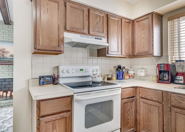 kitchen featuring tasteful backsplash and white range with electric stovetop