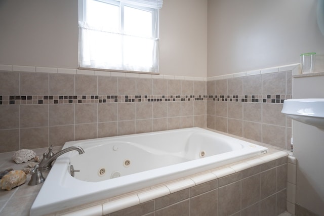 bathroom with a relaxing tiled tub