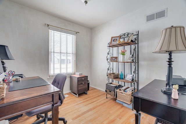 home office featuring plenty of natural light and light hardwood / wood-style flooring