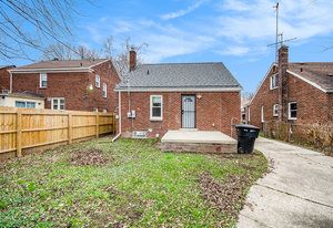 rear view of house with a lawn