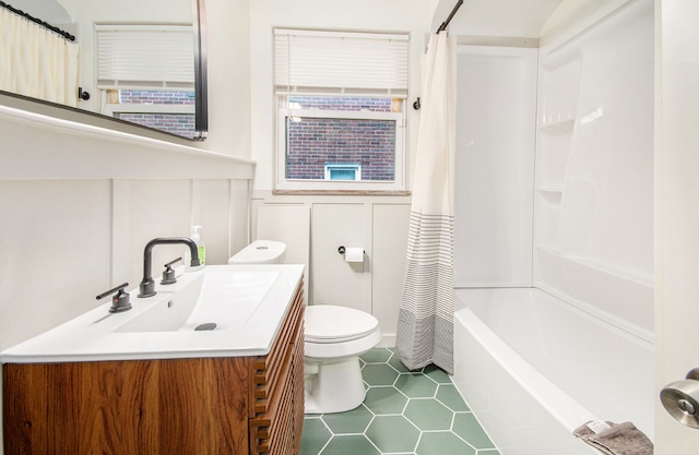 full bathroom featuring vanity, toilet, tile patterned floors, and shower / bathtub combination with curtain