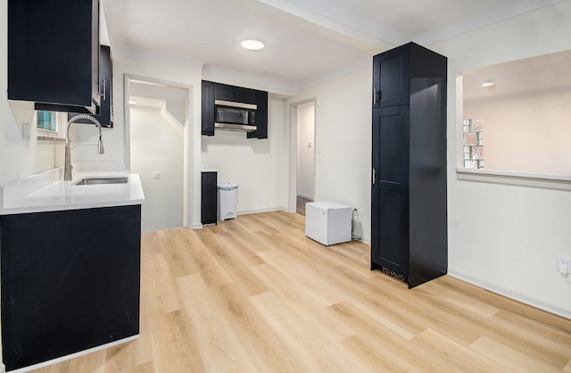 kitchen with sink, light hardwood / wood-style flooring, and a wealth of natural light