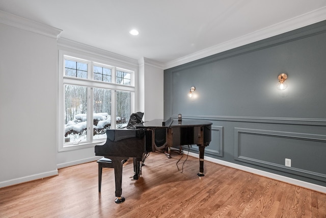 misc room featuring ornamental molding and light hardwood / wood-style floors