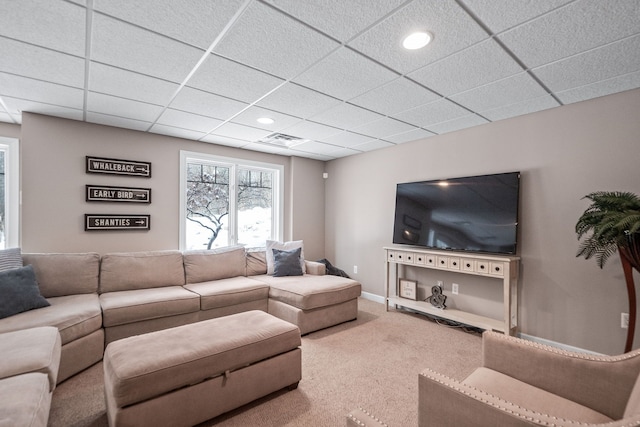 carpeted living room featuring a paneled ceiling