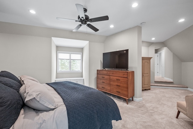 bedroom featuring ceiling fan, light carpet, and vaulted ceiling