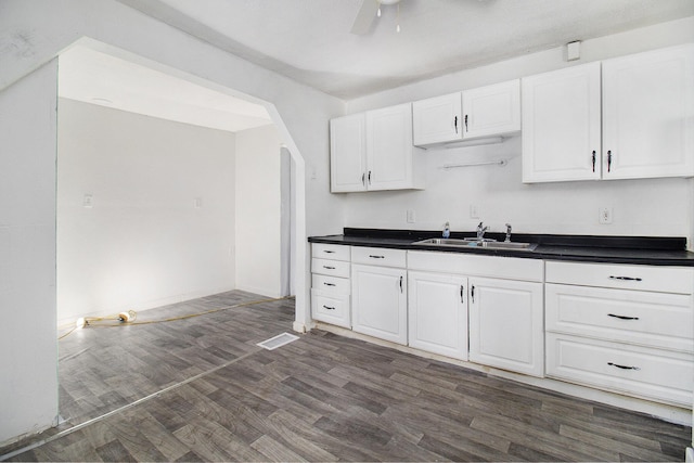 kitchen featuring ceiling fan, white cabinets, dark hardwood / wood-style floors, and sink