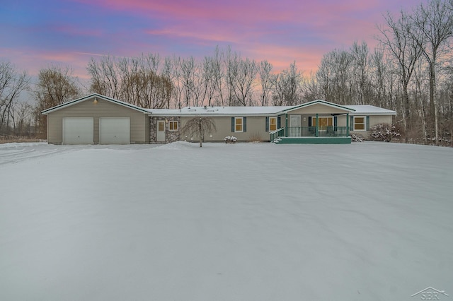 view of front of property featuring covered porch and a garage