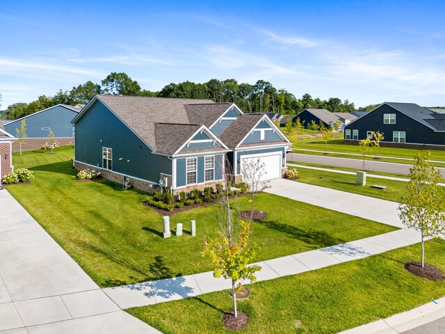 craftsman-style house featuring a front lawn and a garage